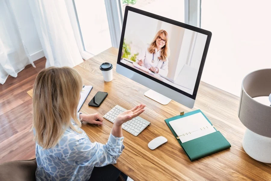 virtual-iop-programs-near-me a woman video calling her therapist during virtual iop