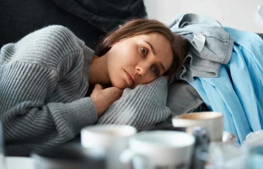anxious woman resting on a sofa in fight-or-flight state