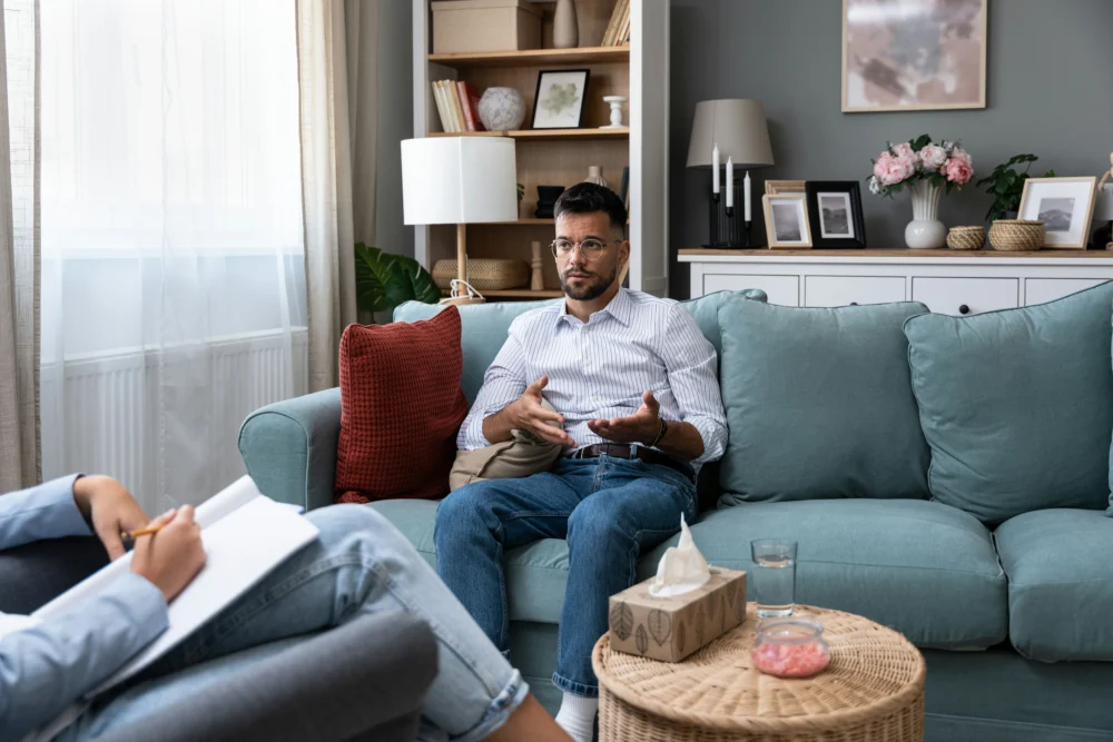 a-man-speaking-to-therapist-in-session