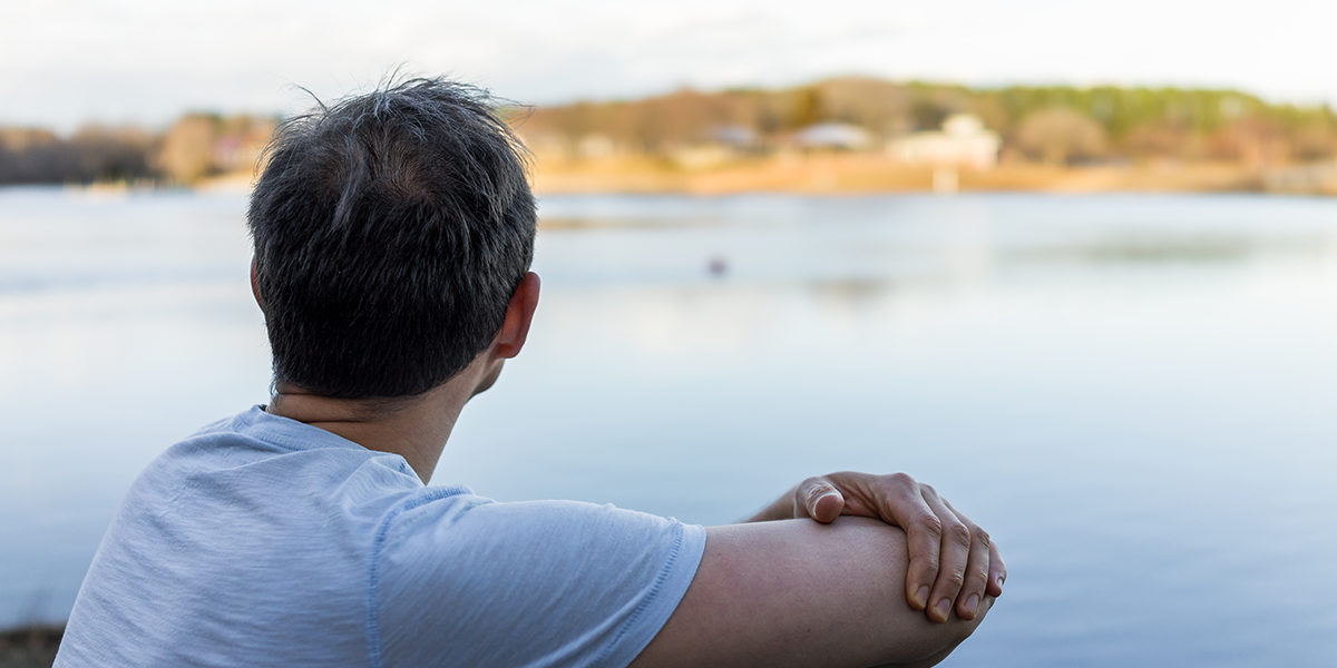 man looking out over water avoiding drug use