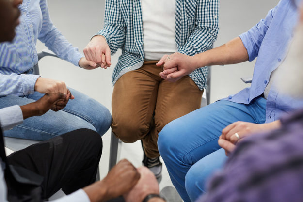 individuals in group therapy at addiction recovery