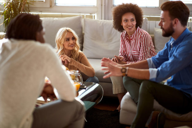 individuals talking in sober living home