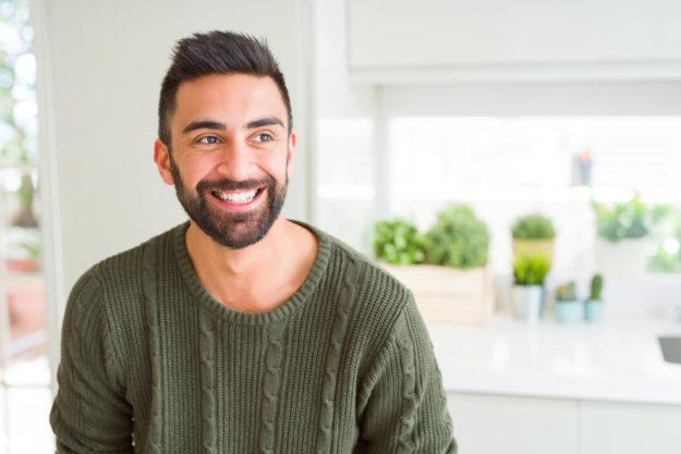 guy smiling after learning how sober living homes could prevent relapse