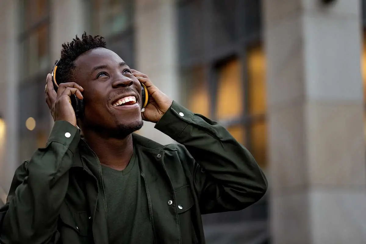 man listening to headphones after learning about what aftercare for addiction is
