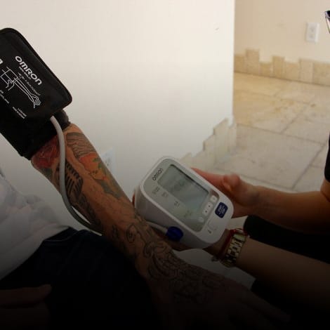 man getting blood pressure checked at medication assisted treatment