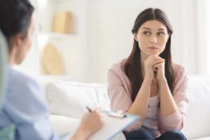 woman listening to therapist about opioid addiction treatment program 