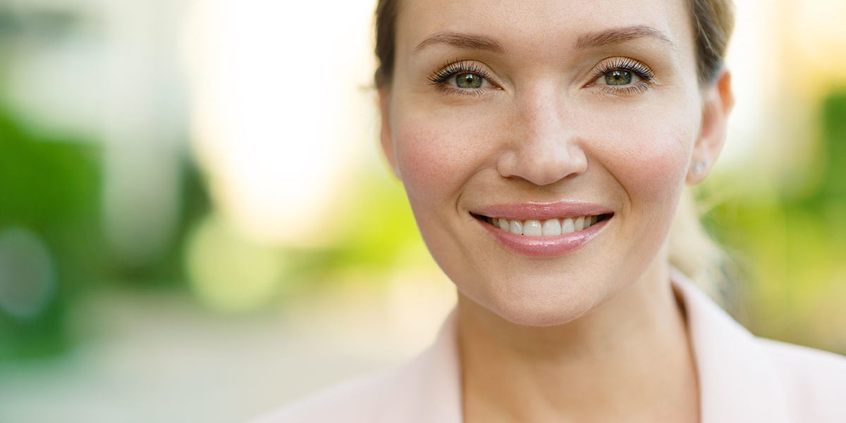 woman smiling outside knowing there is safety at rehab