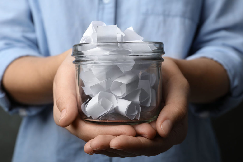 person holding a gratitude jar