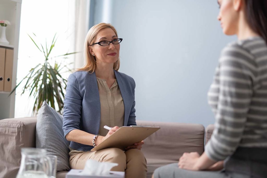 a woman is happy to work at a mental health treatment center