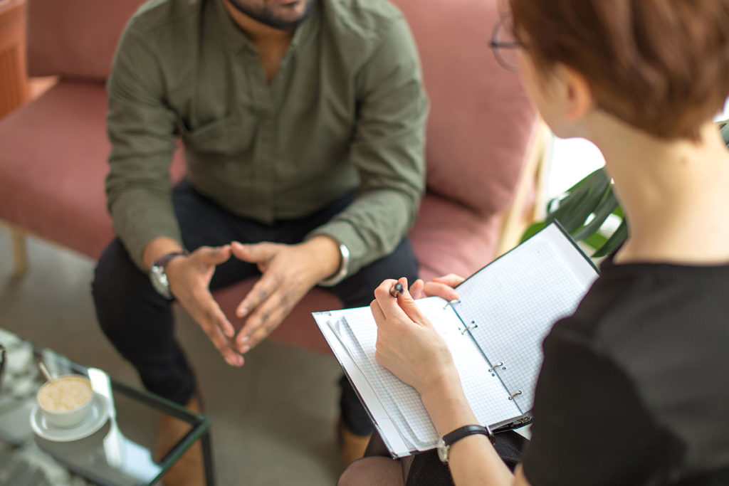 man discusses substance abuse treatment with therapist