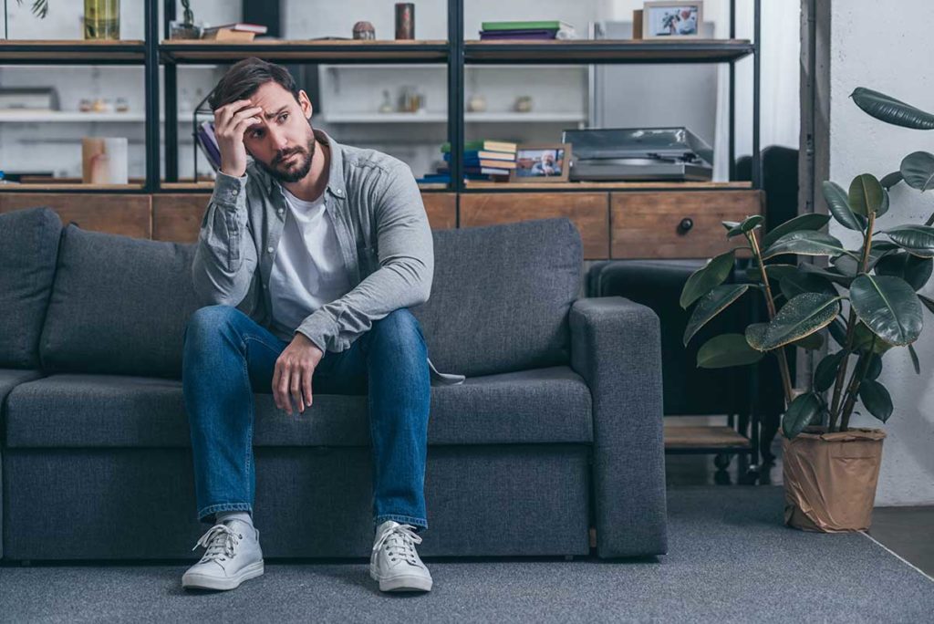 man struggles with signs of heroin addiction