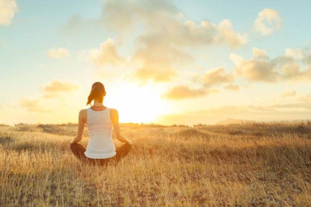 a woman considers reducing anxiety through meditation by practicing meditation for anxiety