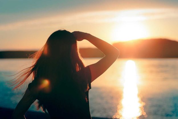 woman looking at sun rise trying to have a sober new year