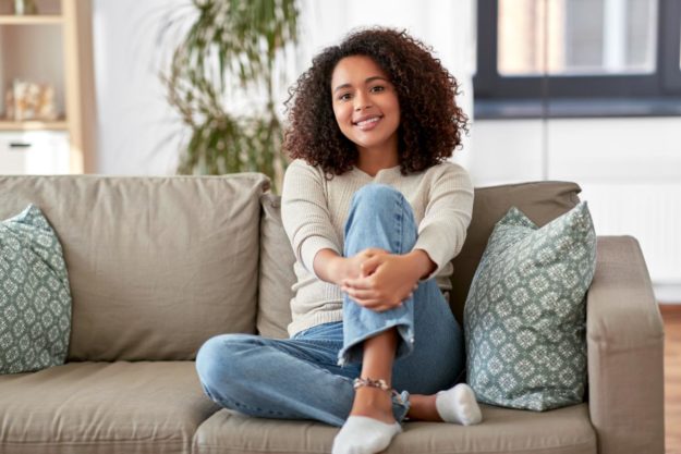 girl sitting on the couch learning about detoxing from alcohol at home
