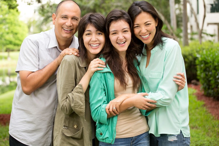 Portrait of a happy family successfully recovering at a sober living PHP house