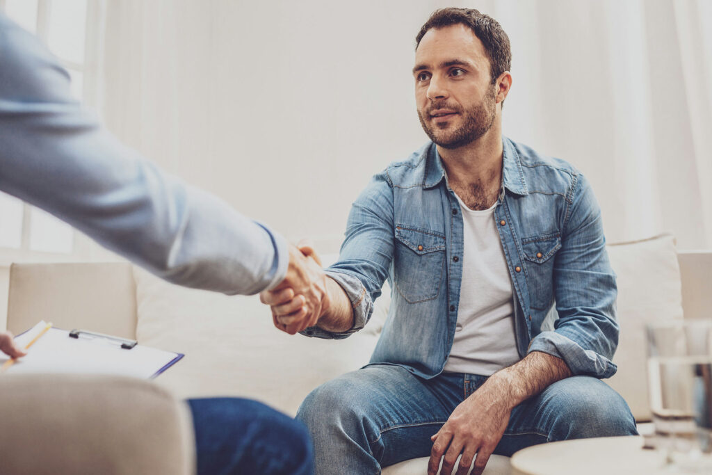 a-man-shaking-hands-with-his-therapist