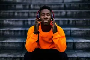 a man listening to music is an example of an activity used in experiential therapy programs.