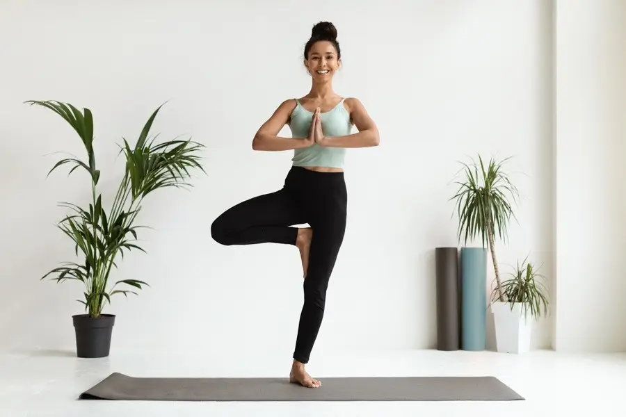 girl practicing yoga as part of holistic therapy