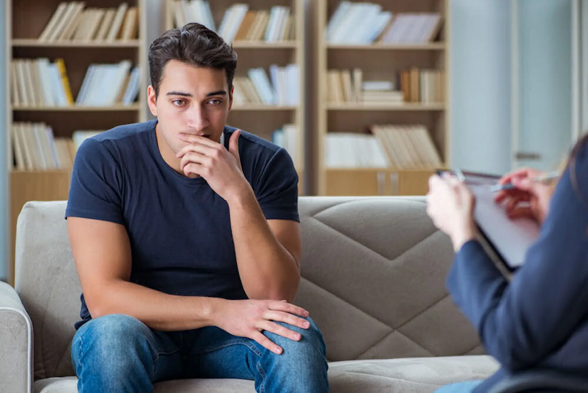man sitting on couch during cocaine addiction treatment