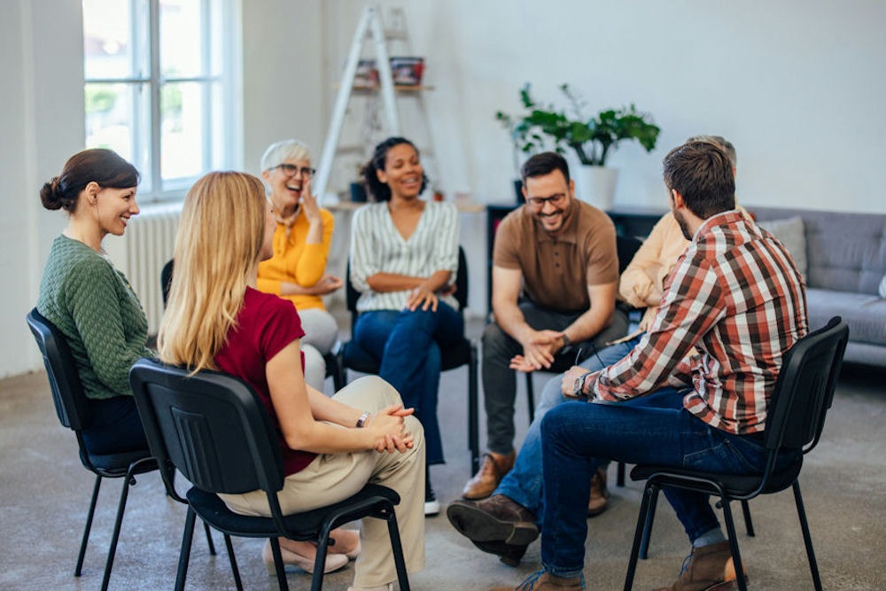 a-group-of-people-smiling-in-a-therapy-session