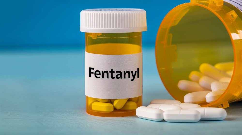 a-fentanyl-bottle-and-pills-spilling-out