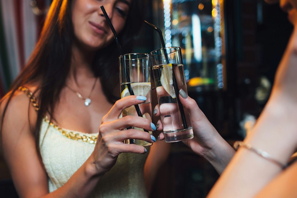 women-toastting-with-sparkling-water-and-lemon