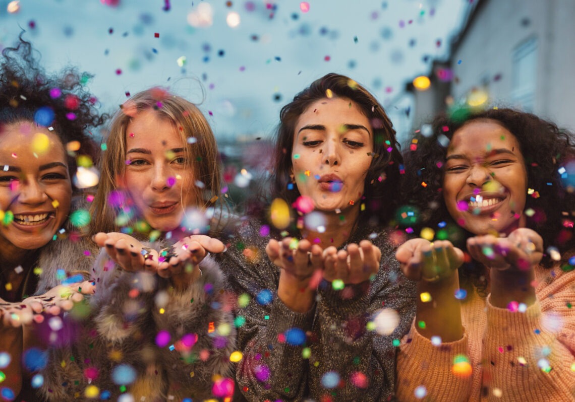 women-partying-blowing-confetti