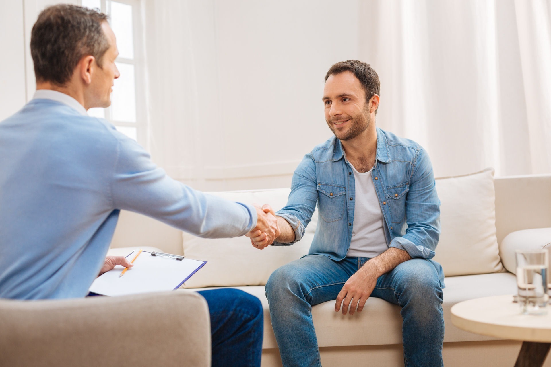 a man shaking hands with therapist