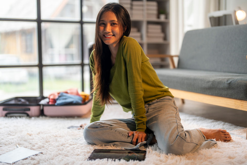 a-woman-sitting-down-smiling-packing-for-rehab