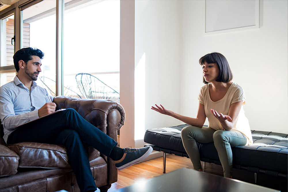 a-woman-with-her-hands-out-in-therapy