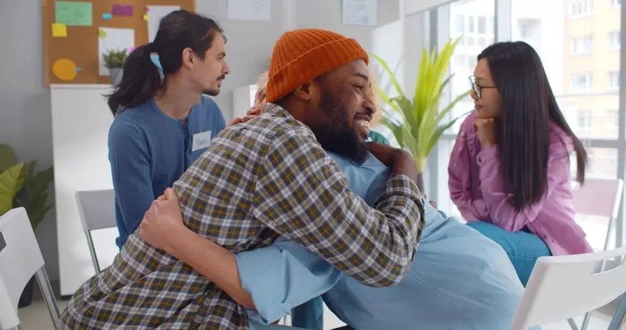 a man and woman hugging in recovery