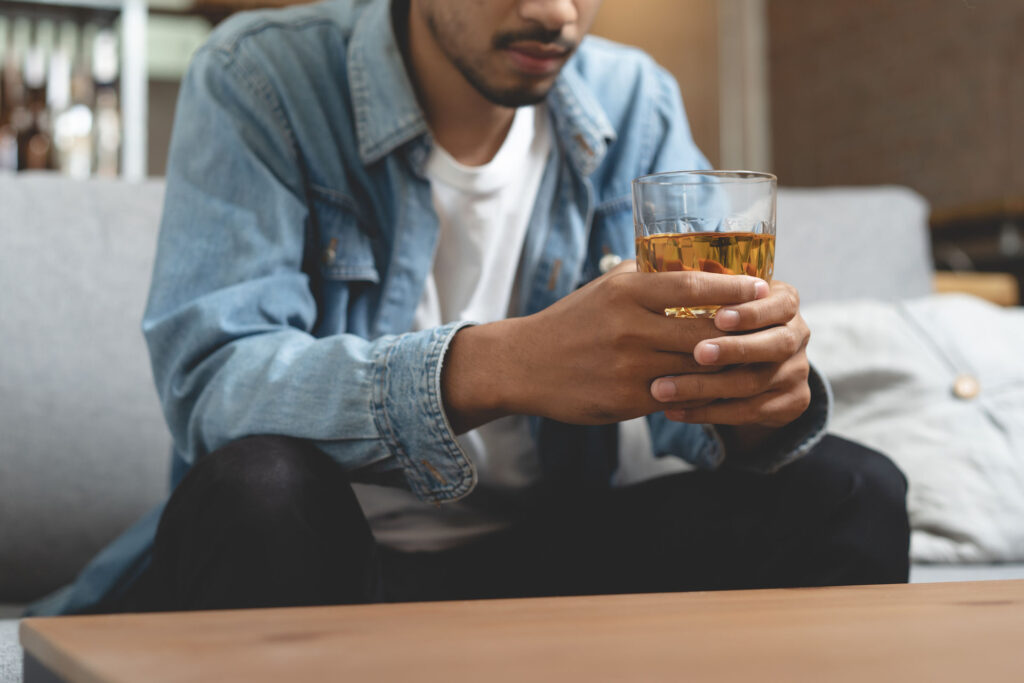 a-man-holding-a-glass-of-beer