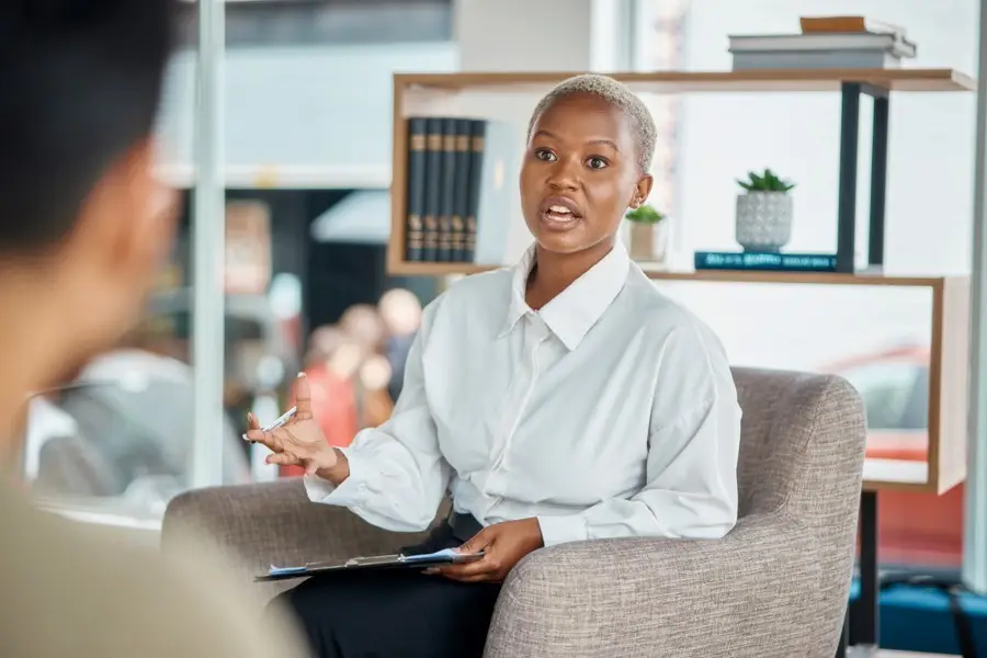 a therapist speaking to her patient in the office