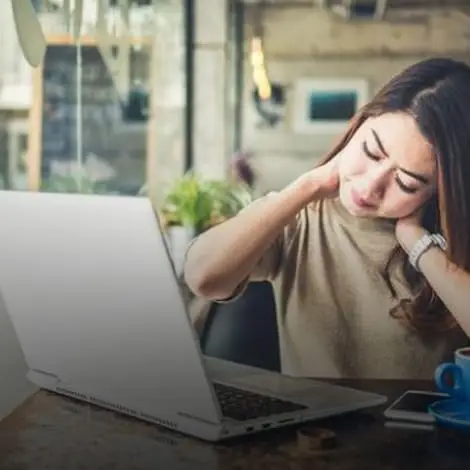 woman with neck pain and fatigue seeking chronic care at holistic center