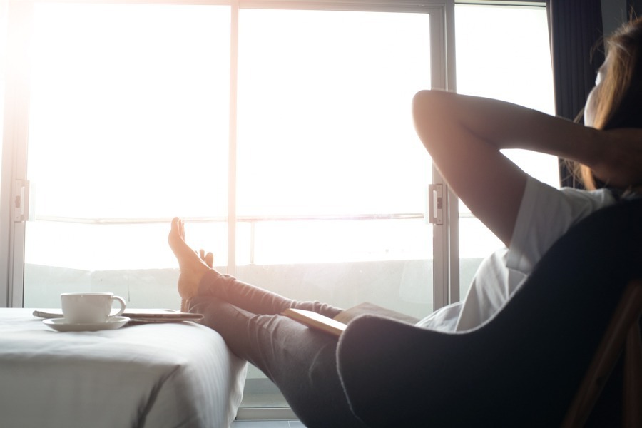 a woman relaxing with her feet up on the bed