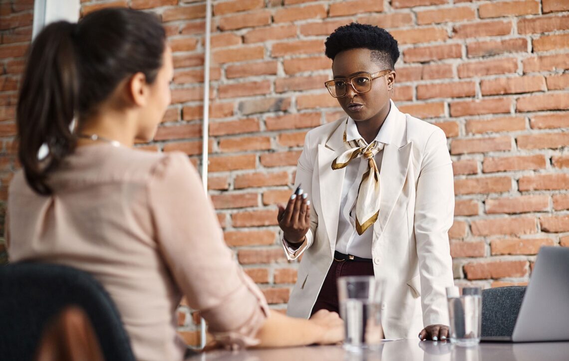 a woman and her boss speaking in the office