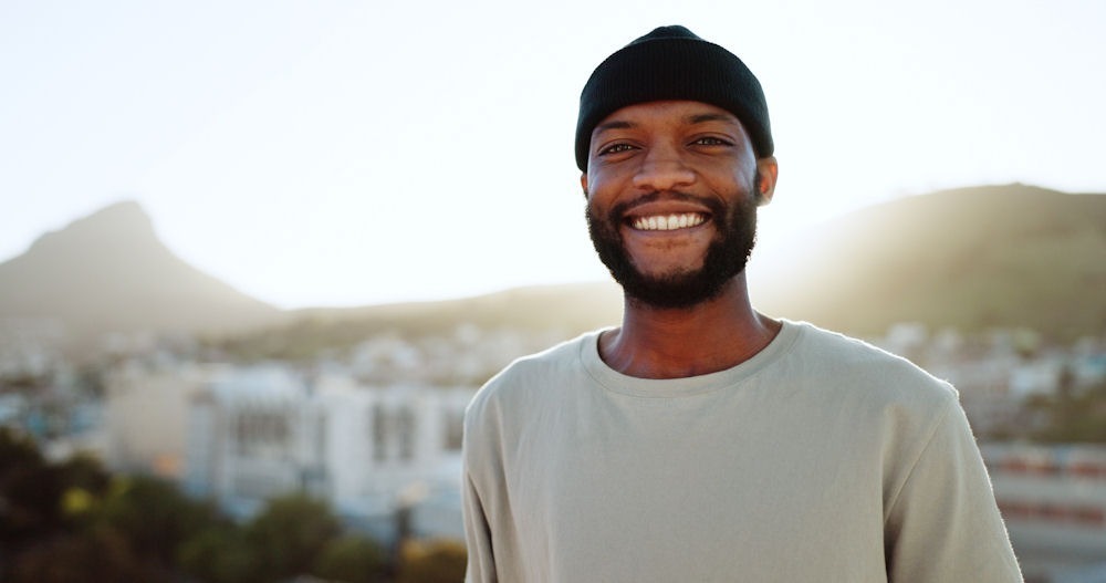 happy man standing outside smiling