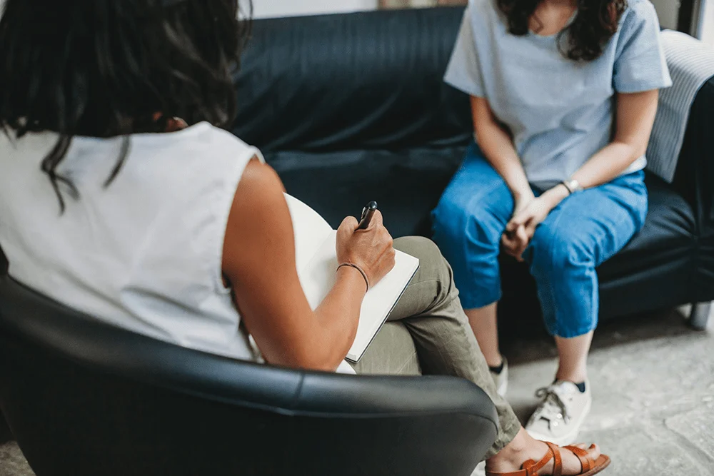 woman sitting and talking with her therapist in act therapy program in Los Angeles