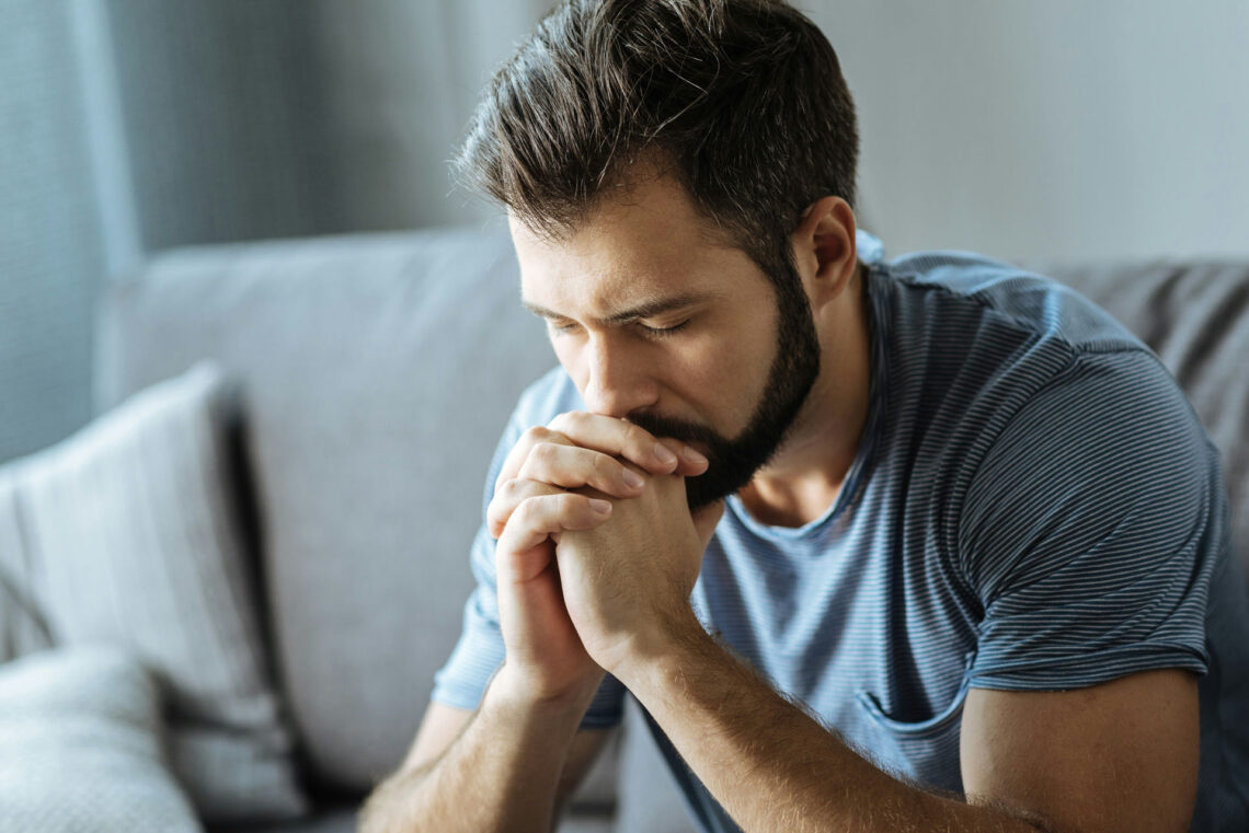 man sitting quietly and reflecting on winter wellness and self-care