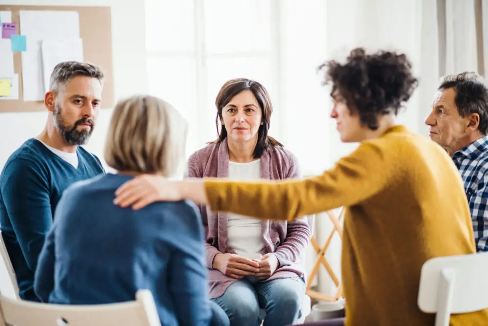 a-woman-being-comforted-in-group-therapy